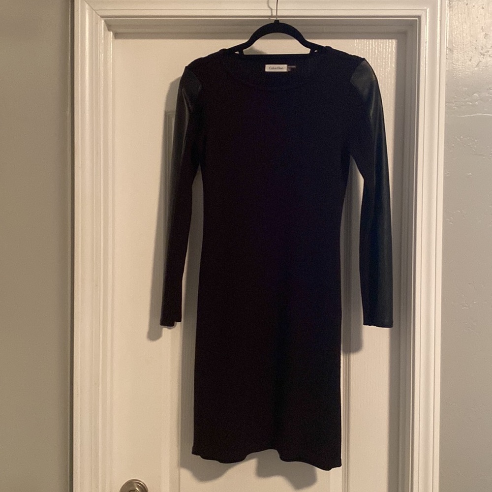 Black Calvin Klein ribbed dress with faux leather sleeves.